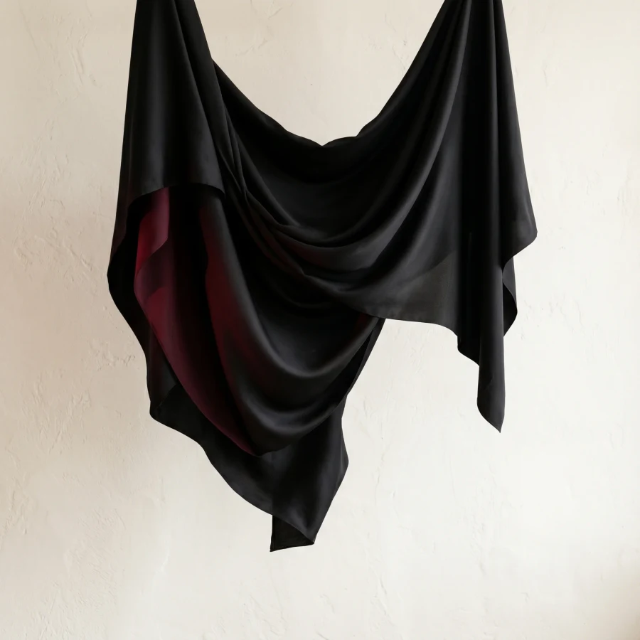 Black silk campaign texture with a wine red accent